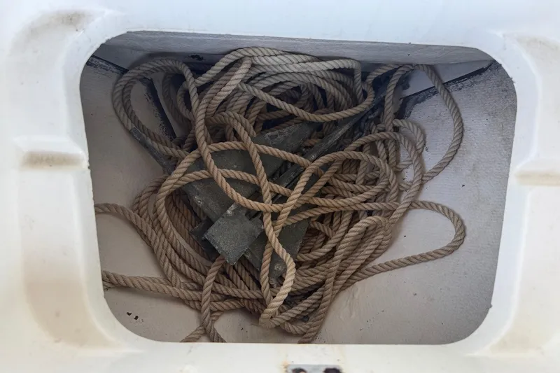 Slide: The Image of Rope and anchor stored in a compartment of a 2006 BlackJack 224 boat. - 28