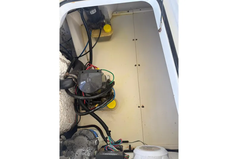 Slide: The Image of Engine compartment of a 2006 BlackJack 224 boat, showing wiring and components. - 29