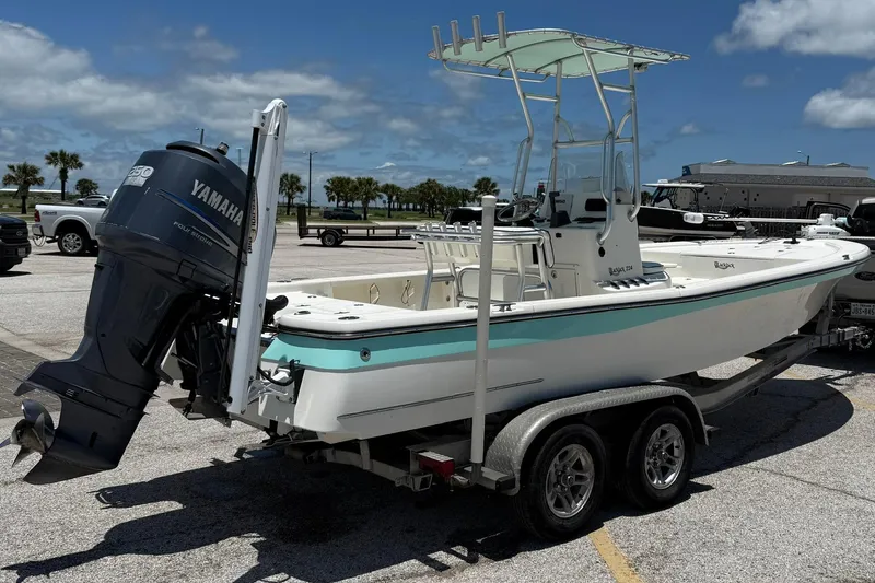 Slide: The Image of 2006 BlackJack 224 boat on trailer with Yamaha engine, parked in sunny marina. - 6