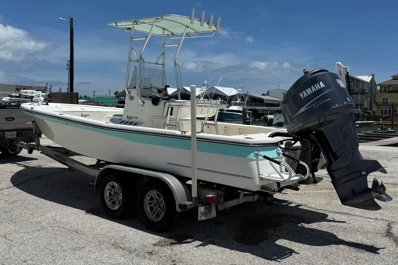Slide: The Image of 2006 BlackJack 224 boat on trailer with Yamaha outboard motor, parked in marina. - 8