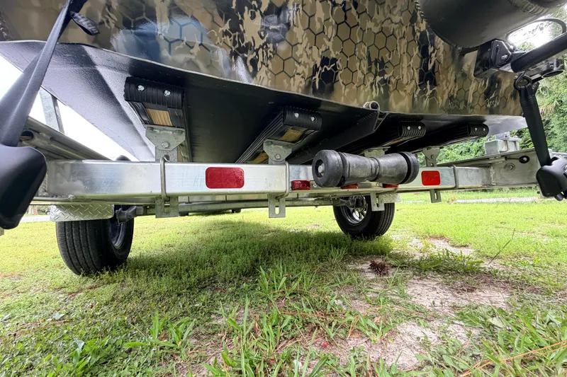 Slide: The Image of Underneath view of a 2024 Prodigy 1854 boat trailer on grass. - 17