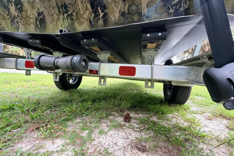 Slide: The Image of Underneath view of 2024 Prodigy 1854 boat trailer on grass. - 20