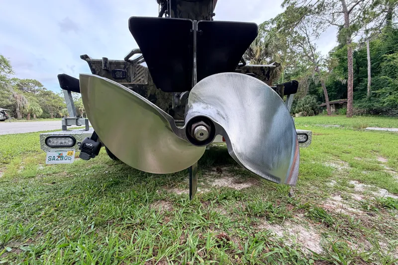 Slide: The Image of Rear view of 2024 Prodigy 1854 boat with large propeller on grass. - 24