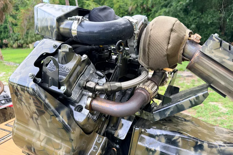 Slide: The Image of Engine of a 2024 Prodigy 1854 with camo design and visible exhaust components. - 27