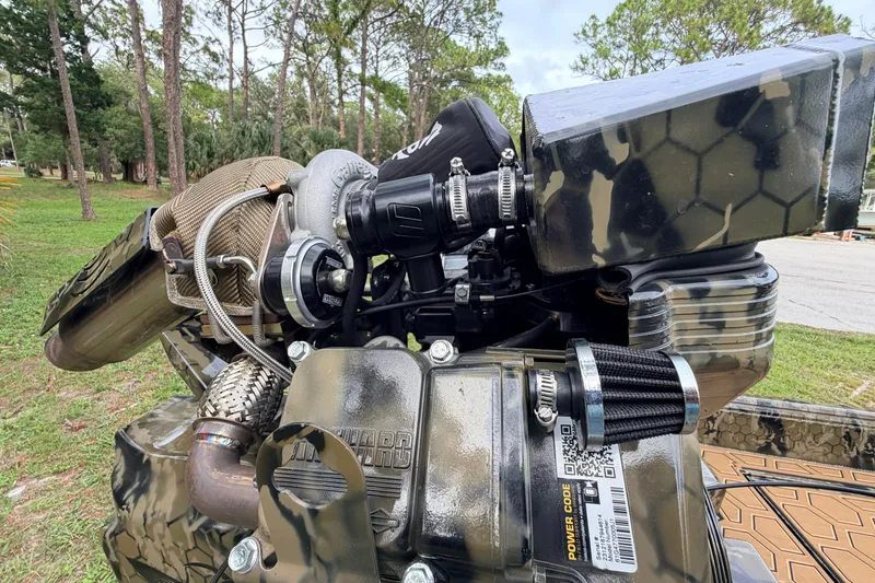 Slide: The Image of Close-up of a 2024 Prodigy 1854 engine with camo design in a wooded area. - 33