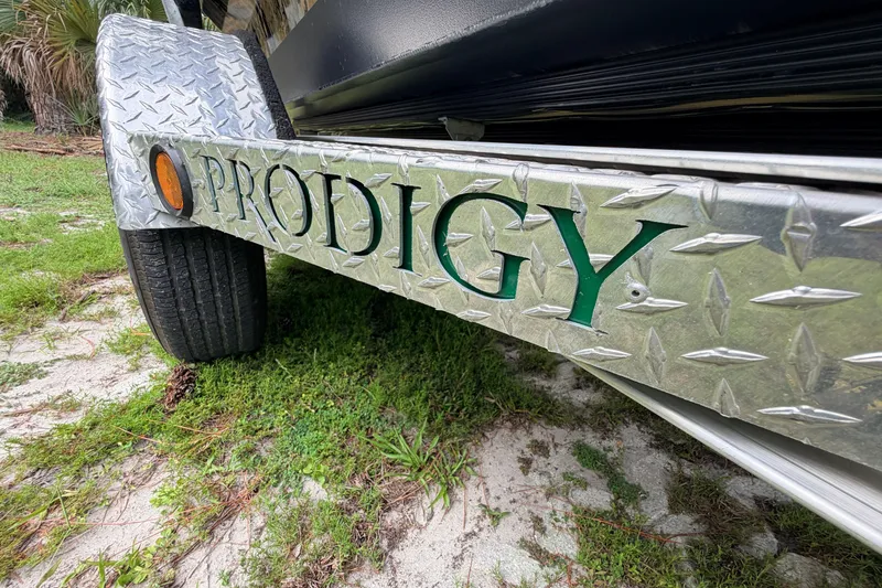 Slide: The Image of 2024 Prodigy 1854 trailer with diamond plate design and green lettering. - 36