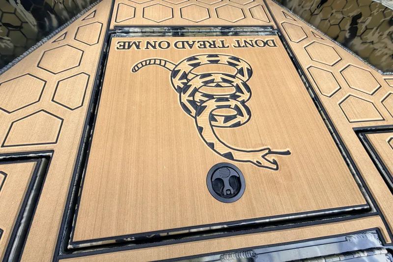 Slide: The Image of Deck of 2024 Prodigy 1854 boat featuring "Don't Tread on Me" design with snake graphic. - 40