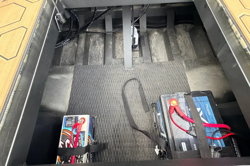 Slide: The Image of View of a boat's battery compartment with two batteries and cables. - 42