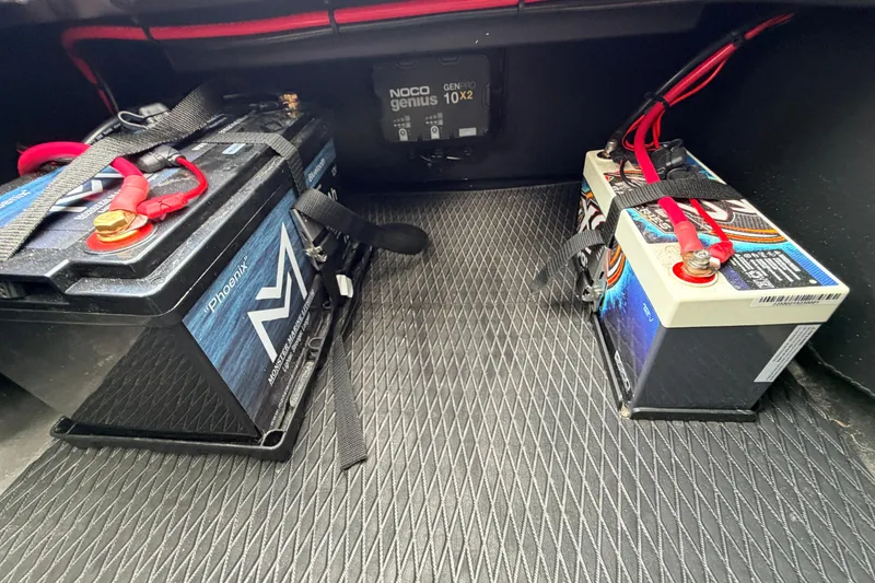 Slide: The Image of Two secured batteries with red cables in a Prodigy 1854, 2024 model. - 43