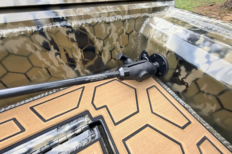 Slide: The Image of Camouflage-patterned interior of 2024 Prodigy 1854 boat with mounted equipment. - 46
