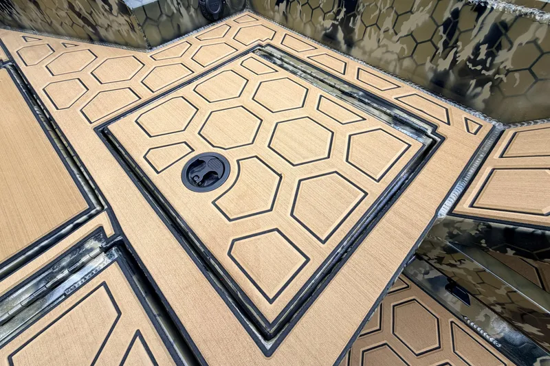 Slide: The Image of Hexagonal patterned deck of 2024 Prodigy 1854 boat, featuring a camo design. - 47