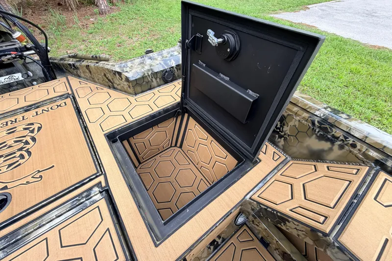 Slide: The Image of Open storage compartment on 2024 Prodigy 1854 boat with hexagonal pattern design. - 48