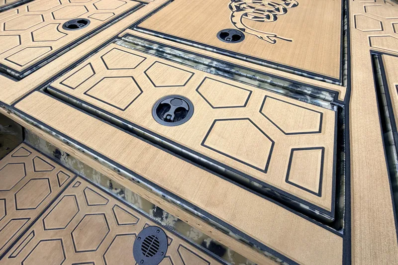 Slide: The Image of Deck of 2024 Prodigy 1854 boat with geometric pattern and storage compartments. - 50