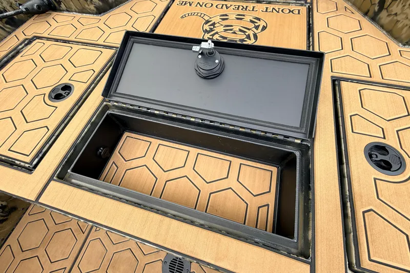 Slide: The Image of Prodigy 1854 boat deck with storage compartment, 2024 model, featuring hexagonal pattern design. - 51