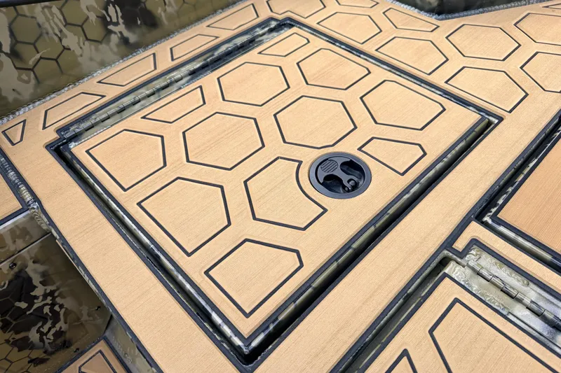 Slide: The Image of Hexagonal patterned deck of 2024 Prodigy 1854 boat, featuring a secure latch. - 52