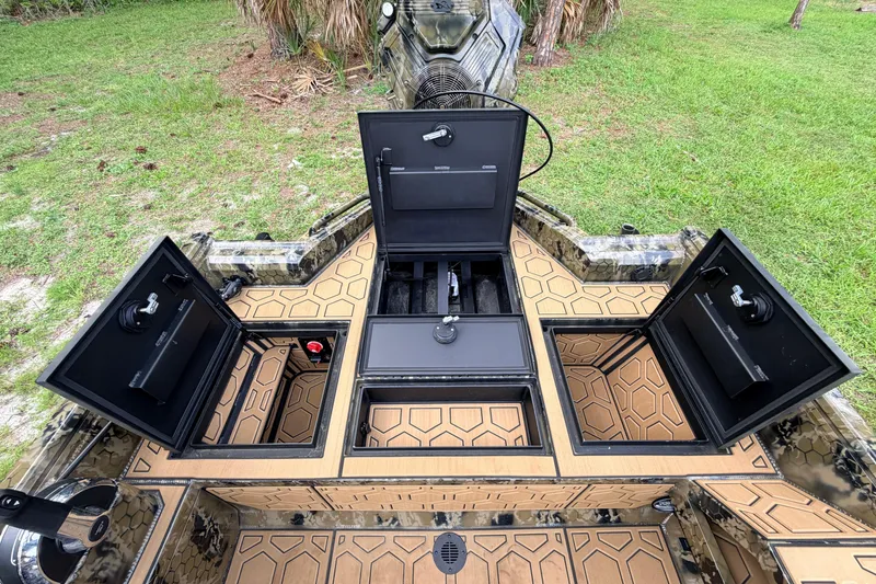 Slide: The Image of Open storage compartments on a 2024 Prodigy 1854 boat, showcasing interior design and functionality. - 55