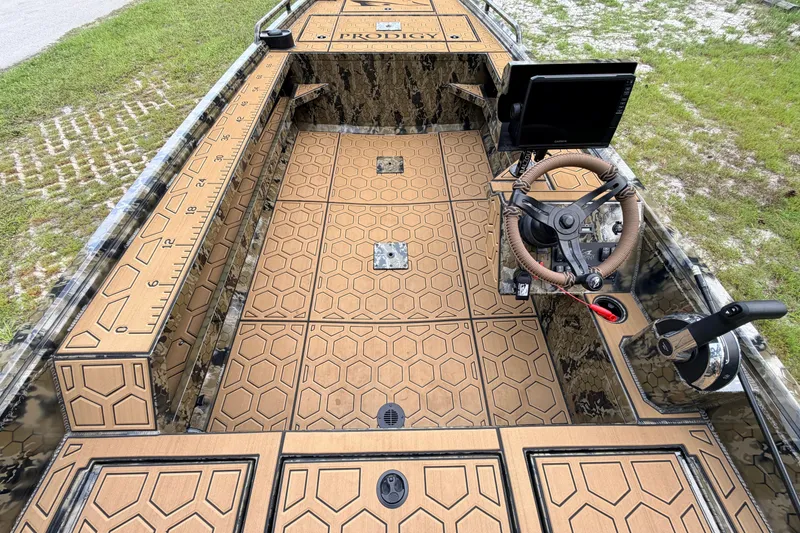Slide: The Image of 2024 Prodigy 1854 boat interior with hexagonal pattern flooring and advanced steering console. - 57