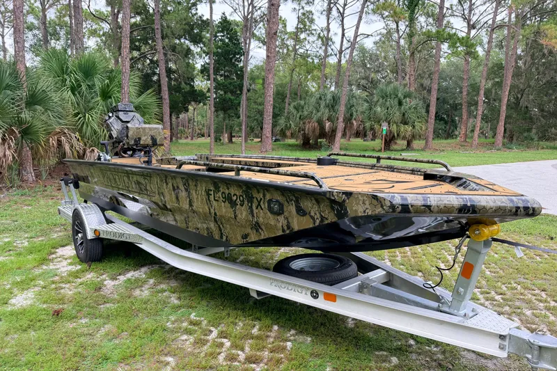 Slide: The Image of 2024 Prodigy 1854 boat on trailer in wooded area. - 6