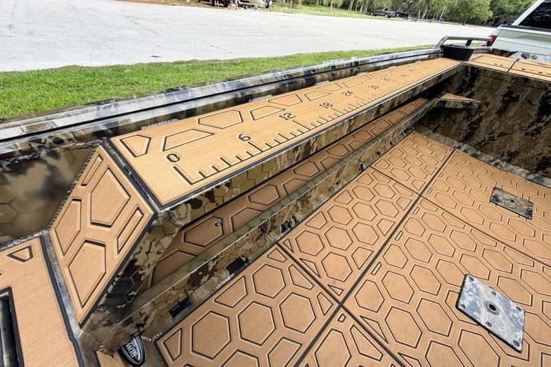 Slide: The Image of 2024 Prodigy 1854 boat interior with camo design and hexagonal pattern flooring. - 63