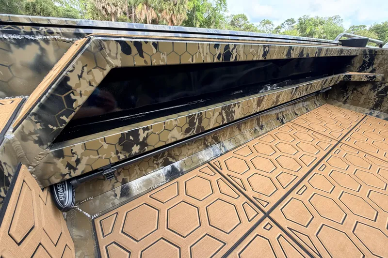 Slide: The Image of 2024 Prodigy 1854 boat interior with camouflage design and hexagonal patterned flooring. - 64