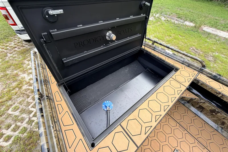 Slide: The Image of Open storage compartment of 2024 Prodigy 1854 boat with hexagonal patterned flooring. - 71