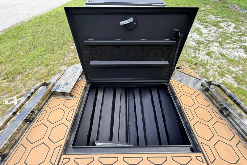 Slide: The Image of Open storage compartment of 2024 Prodigy 1854 boat with hexagonal pattern flooring. - 73