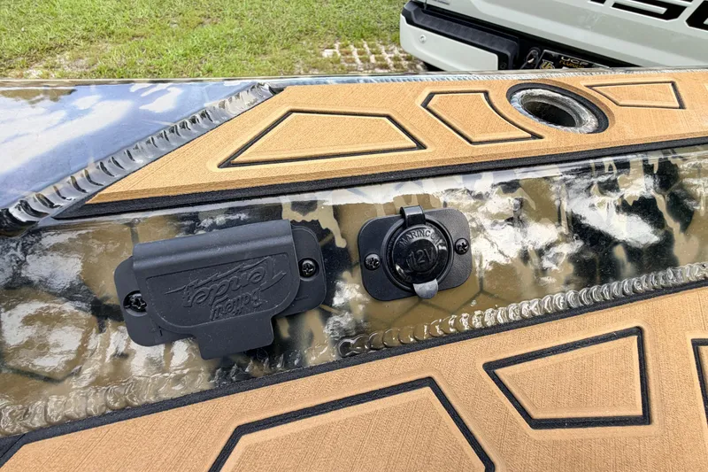 Slide: The Image of Prodigy 1854 boat detail, featuring 12V outlet and textured surface, 2024 model. - 77