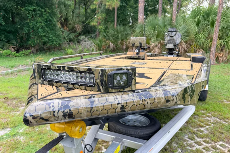 Slide: The Image of Camouflage-patterned Prodigy 1854 boat on trailer, featuring LED lights, 2024 model. - 79