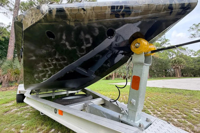 Slide: The Image of 2024 Prodigy 1854 boat on trailer, showcasing hull design and sturdy construction. - 8