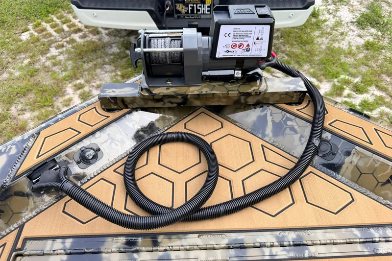 Slide: The Image of Boat deck with camo pattern, featuring a winch system, Prodigy 1854, 2024 model. - 83
