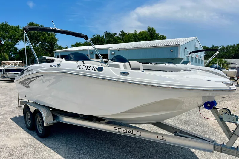 Slide: The Image of 2024 Hurricane Sundeck Sport 218 OB boat on trailer, parked outdoors. - 7