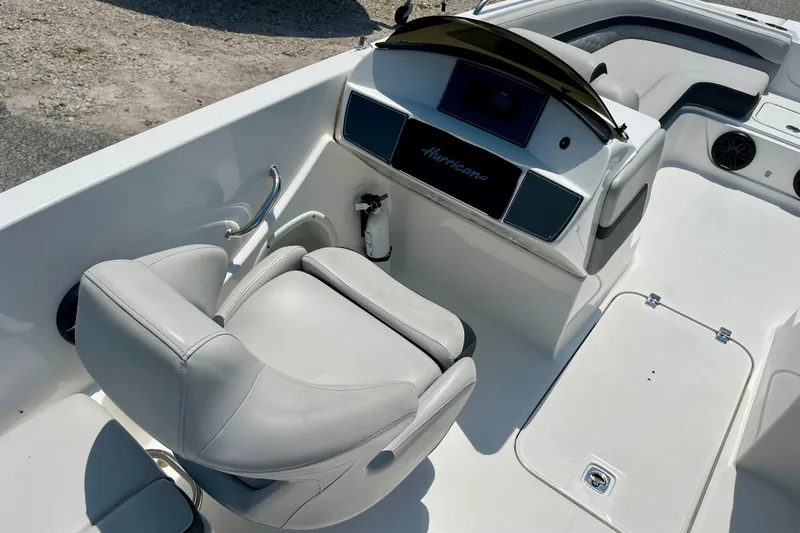 Slide: The Image of 2024 Hurricane Sundeck Sport 218 OB boat interior with helm and seating area. - 11