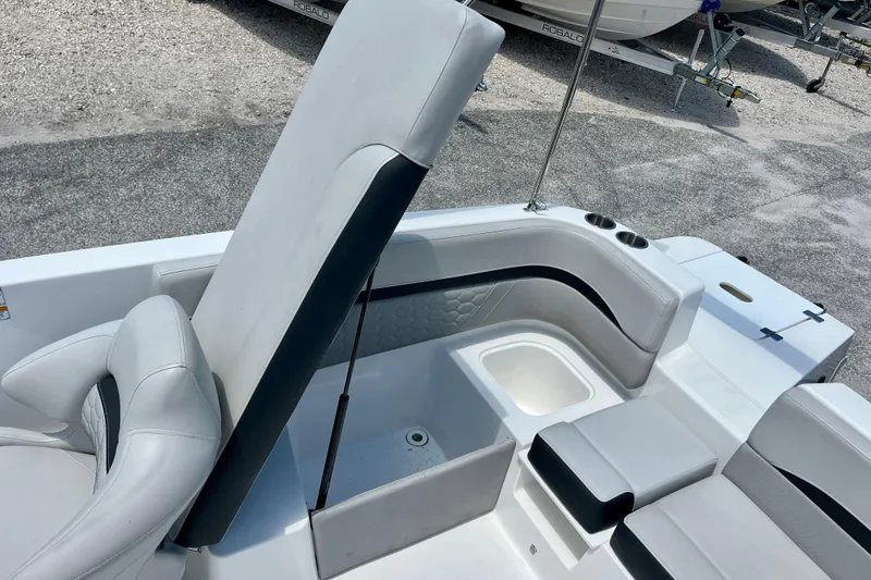 Slide: The Image of 2024 Hurricane Sundeck Sport 218 OB boat interior with white seating and storage compartments. - 20