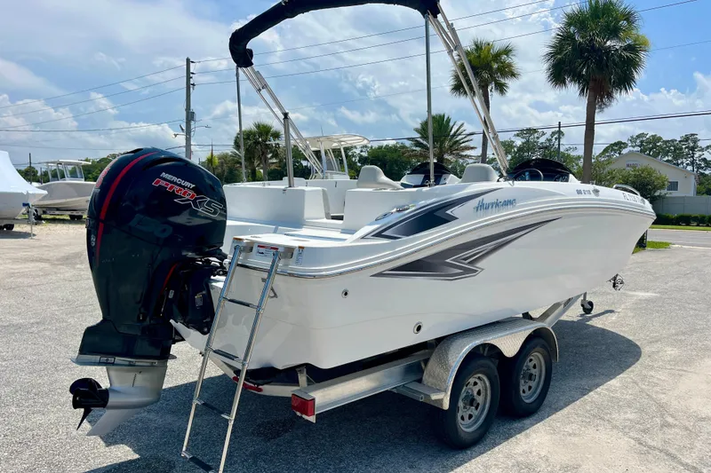 Slide: The Image of 2024 Hurricane Sundeck Sport 218 OB boat on trailer, featuring Mercury Pro XS engine. - 5