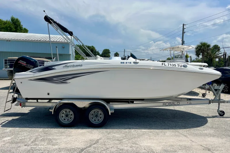 Slide: The Image of 2024 Hurricane Sundeck Sport 218 OB boat on trailer, parked outdoors. - 6