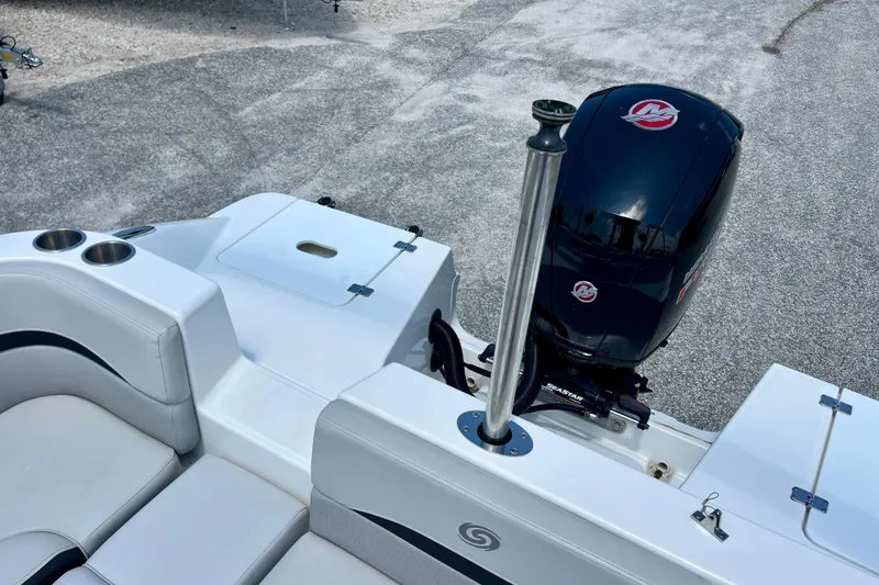 Slide: The Image of 2024 Hurricane Sundeck Sport 218 OB boat with sleek seating and powerful outboard motor. - 21