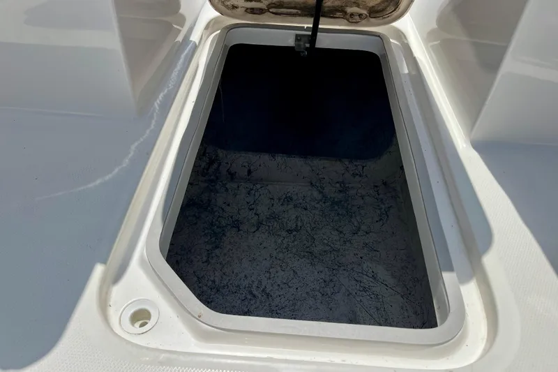 Slide: The Image of Open storage compartment on 2024 Hurricane Sundeck Sport 218 OB boat. - 19