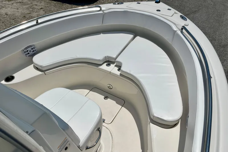 Slide: The Image of 2016 Robalo R222 Center Console boat with cushioned seating area. - 15