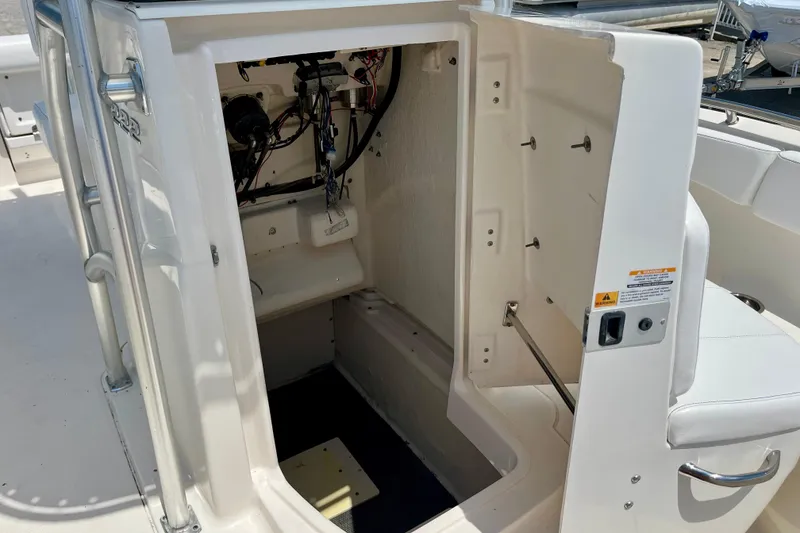 Slide: The Image of 2016 Robalo R222 Center Console boat interior storage compartment with wiring visible. - 17