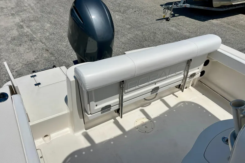 Slide: The Image of 2016 Robalo R222 Center Console boat interior with seating and engine view. - 18