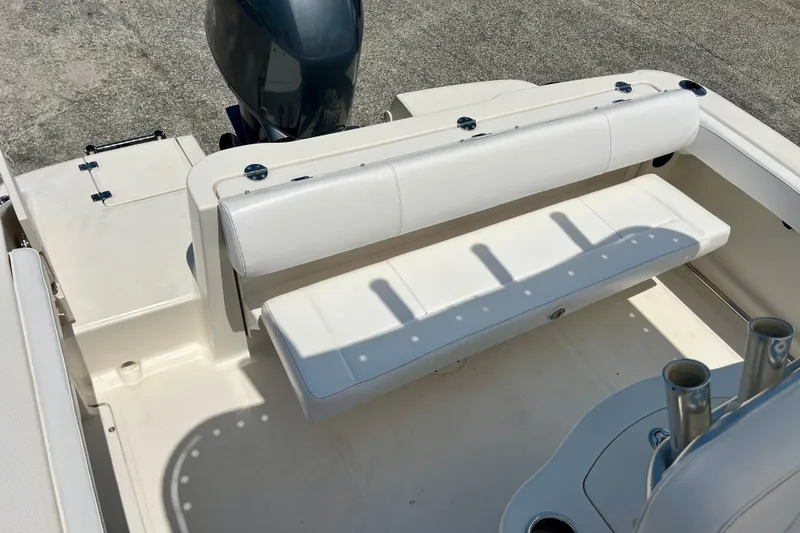 Slide: The Image of 2016 Robalo R222 Center Console boat interior with white seating and rod holders. - 19
