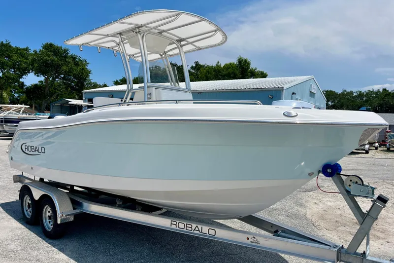 Slide: The Image of 2016 Robalo R222 Center Console boat on trailer, parked outdoors. - 7