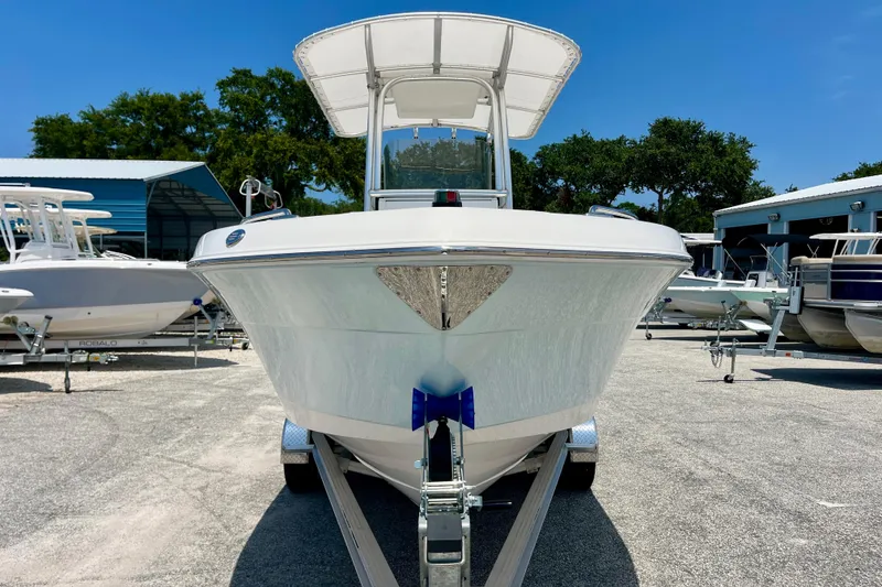 Slide: The Image of 2016 Robalo R222 Center Console boat on trailer, parked outdoors under clear blue sky. - 8