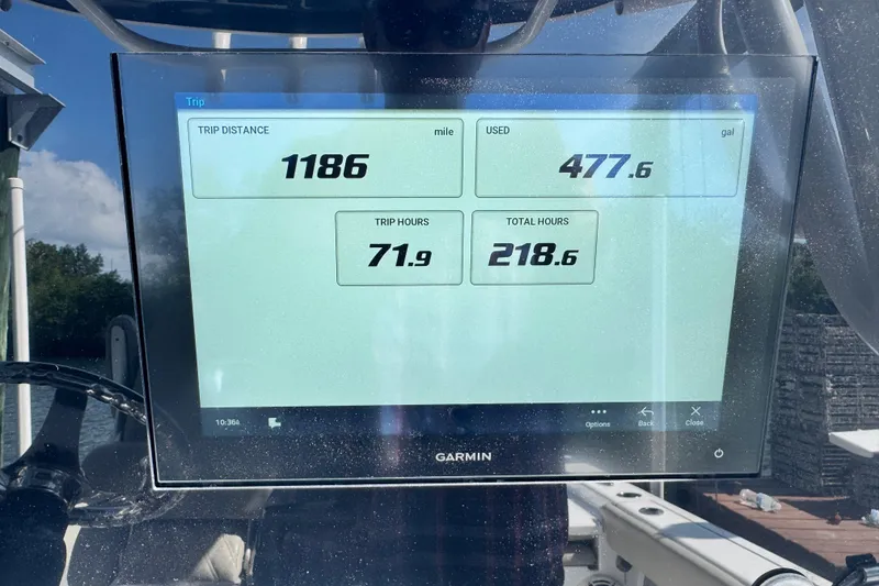 Slide: The Image of Garmin display on 2021 Sportsman Masters 267 Bay Boat showing trip data: distance, fuel, hours. - 14