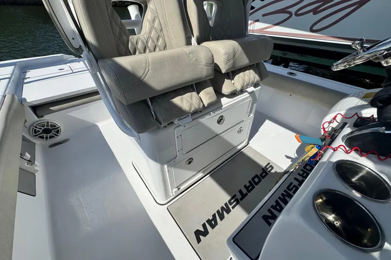 Slide: The Image of 2021 Sportsman Masters 267 Bay Boat interior with cushioned seats and console details. - 16
