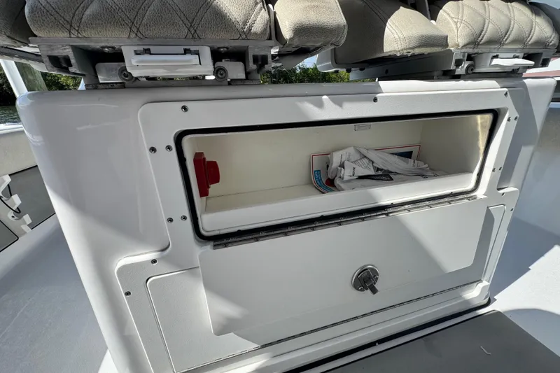 Slide: The Image of Storage compartment on a 2021 Sportsman Masters 267 Bay Boat, featuring cushioned seating. - 17