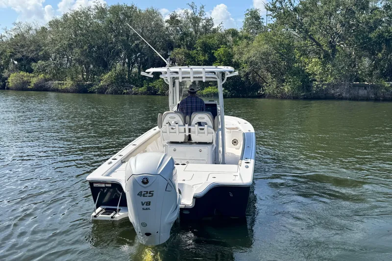 Slide: The Image of 2021 Sportsman Masters 267 Bay Boat cruising on a serene river. - 2