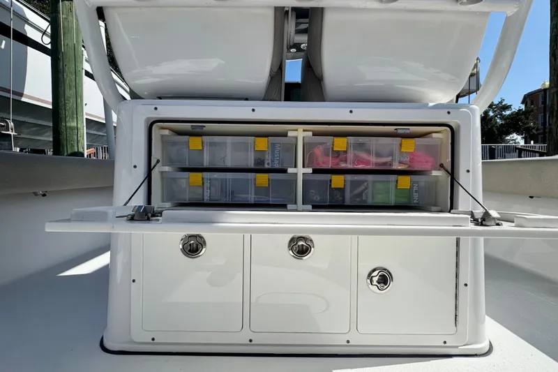 Slide: The Image of 2021 Sportsman Masters 267 Bay Boat tackle storage with organized compartments and secure latches. - 20