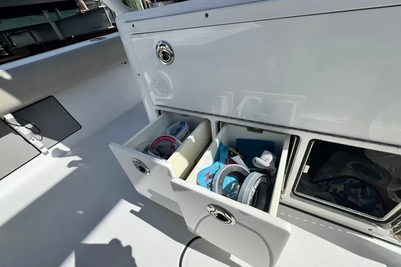 Slide: The Image of Storage compartments on a 2021 Sportsman Masters 267 Bay Boat, featuring organized fishing gear. - 21