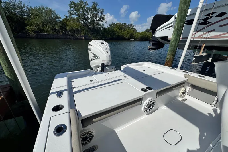 Slide: The Image of 2021 Sportsman Masters 267 Bay Boat docked, featuring Yamaha V8 outboard engine. - 22